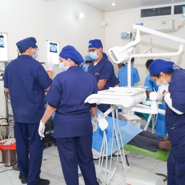 Group of dental students observing implantology demonstration