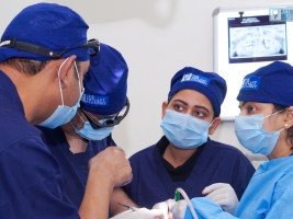 Instructor guiding student during oral implant training session